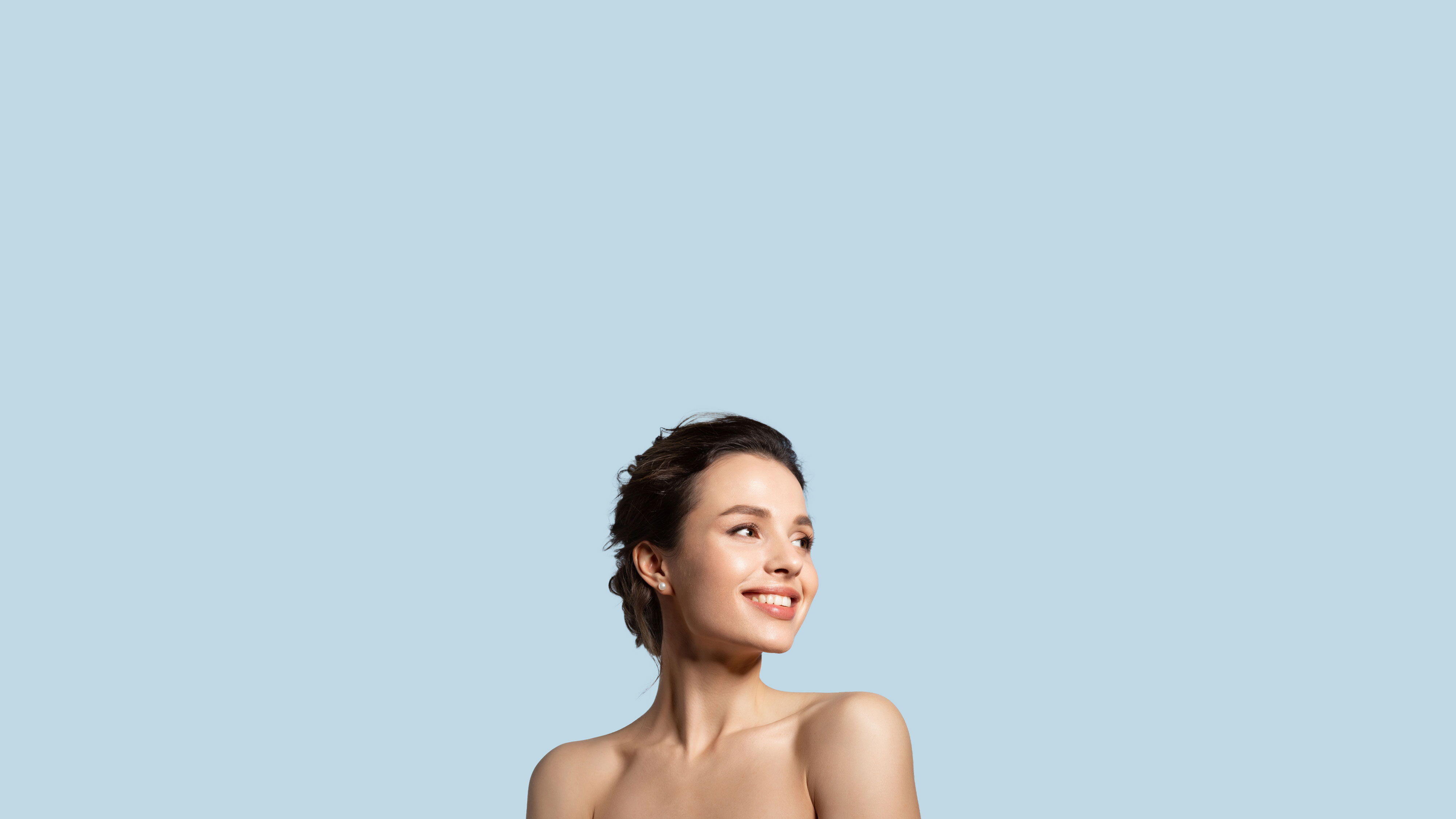 Smiling woman with glowing, healthy skin posing for a personalized skincare quiz banner.