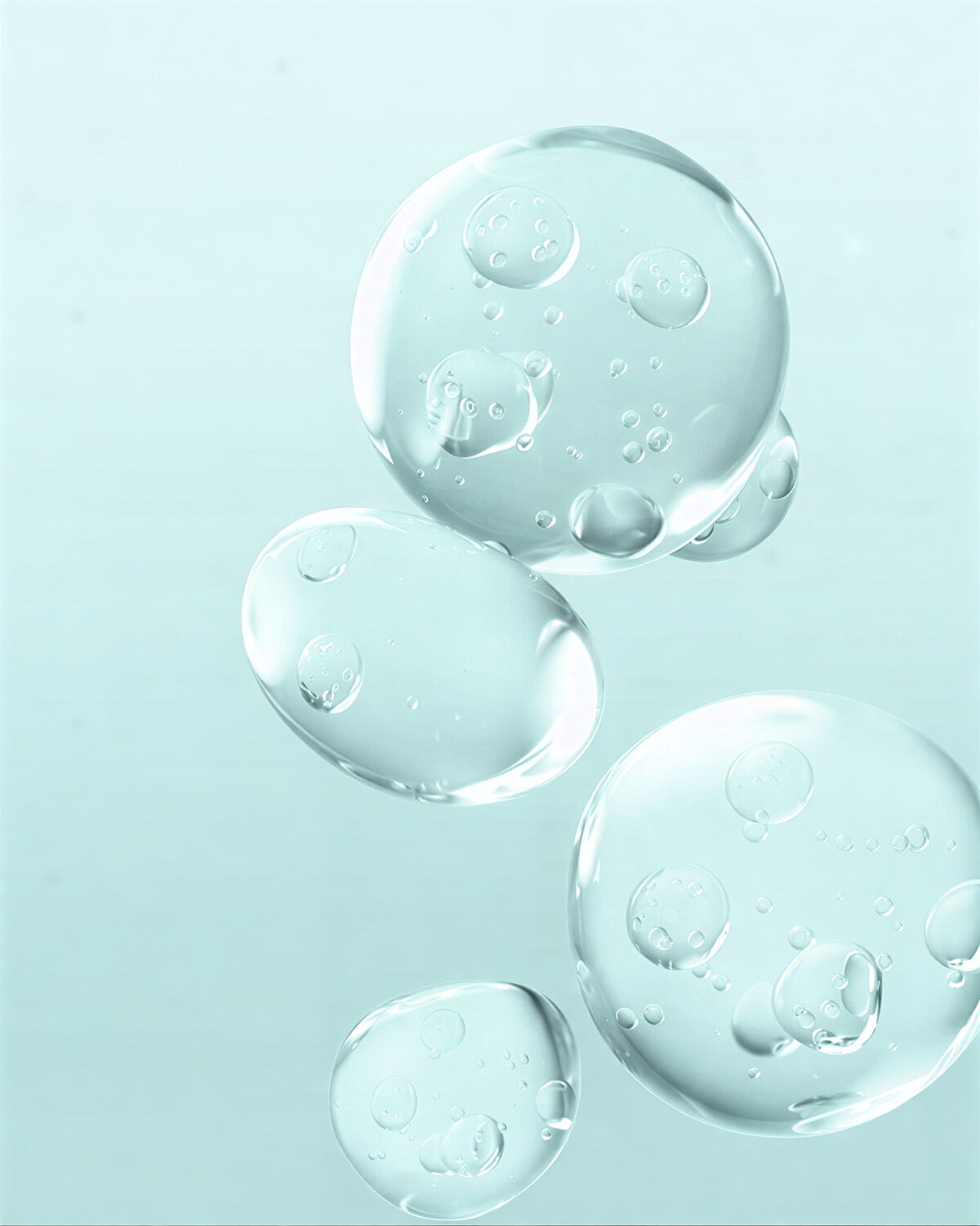 Close-up view of transparent resveratrol serum bubbles floating against a pale blue background, indicating active skincare ingredients.