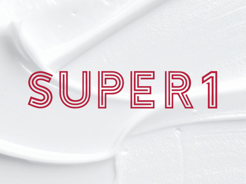 Close-up view of a thick white skincare cream texture with the red outlined text 'SUPER1' overlayed centrally.